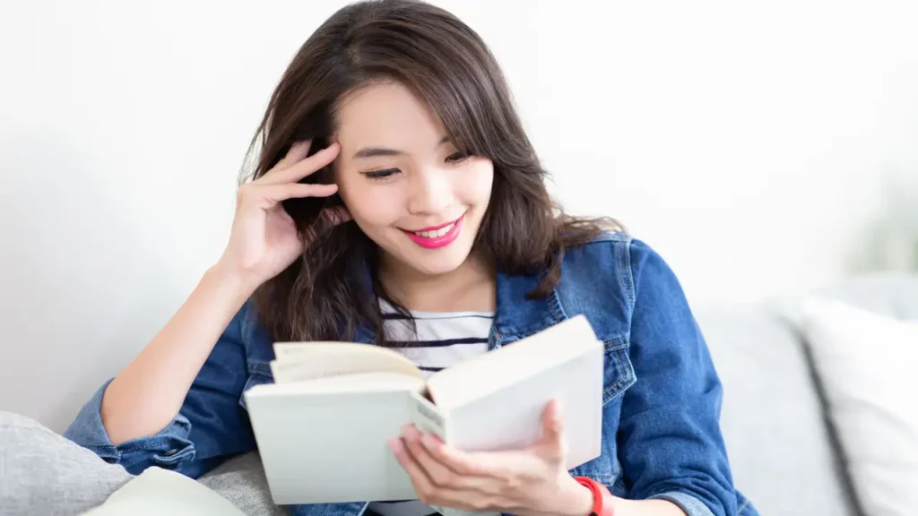 Woman reading a book given as a gift improving her employee engagement