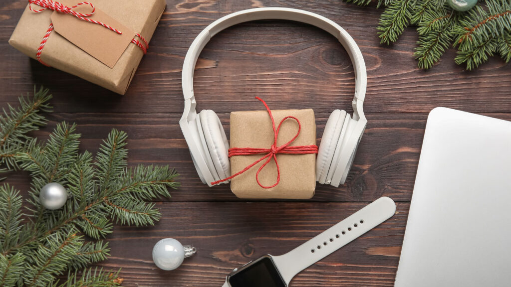 wireless headphones and a wrapped gift box placed on a desk